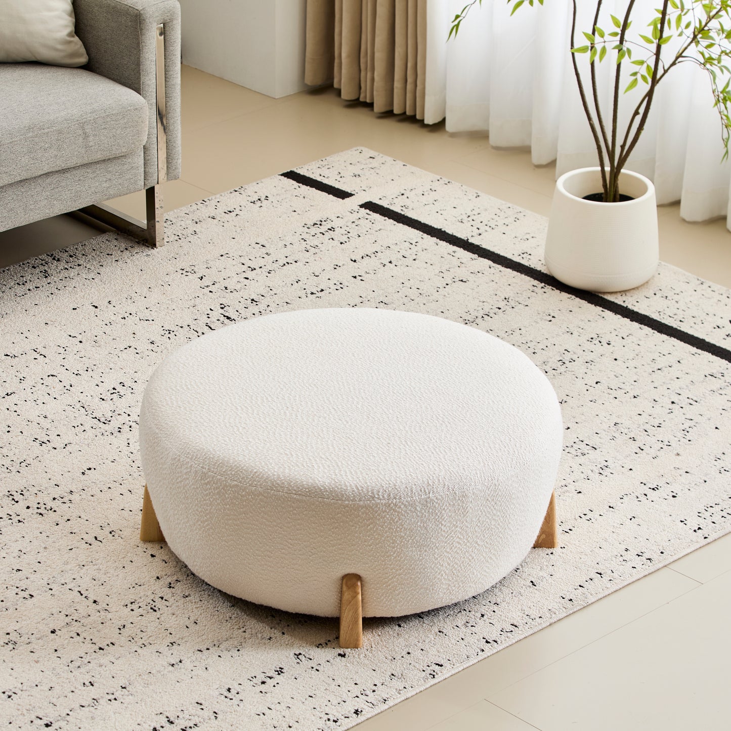 Modis Round Ottoman: Boucle Top with Splayed Rubber Wood Legs